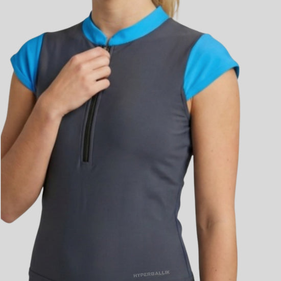 Gray sleeveless top with blue shoulders on a model against a light gray background