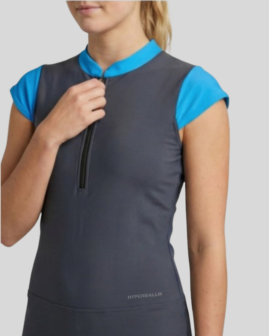 Gray sleeveless top with blue shoulders on a model against a light gray background