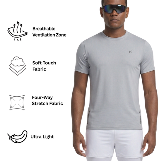Man wearing a gray t-shirt and white shorts with text on fabric features.