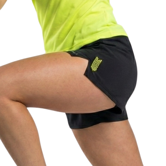 Person wearing black athletic shorts with a logo on a white background