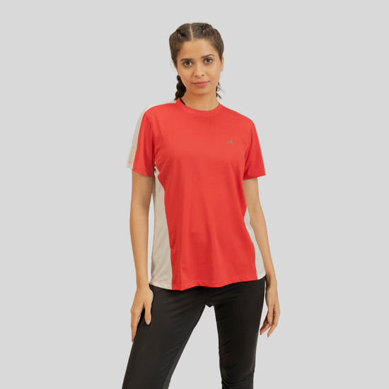 Woman wearing a red and beige athletic shirt with a logo on a gray background