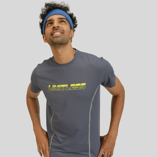 Man wearing a gray athletic shirt with yellow text on a light gray background