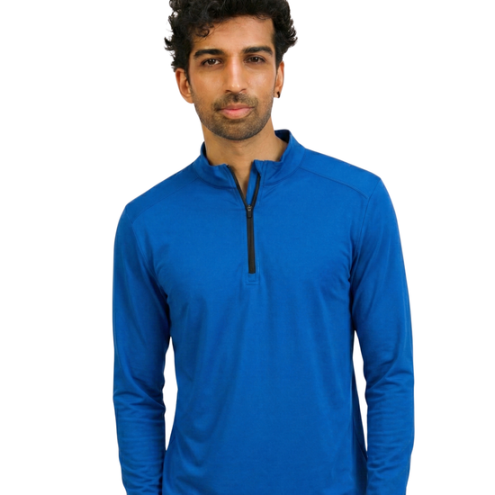 Man wearing a blue long-sleeve shirt with a black zipper on a white background