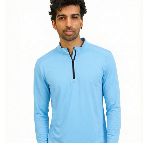 Man wearing a light blue long-sleeve shirt with a quarter zip on a white background