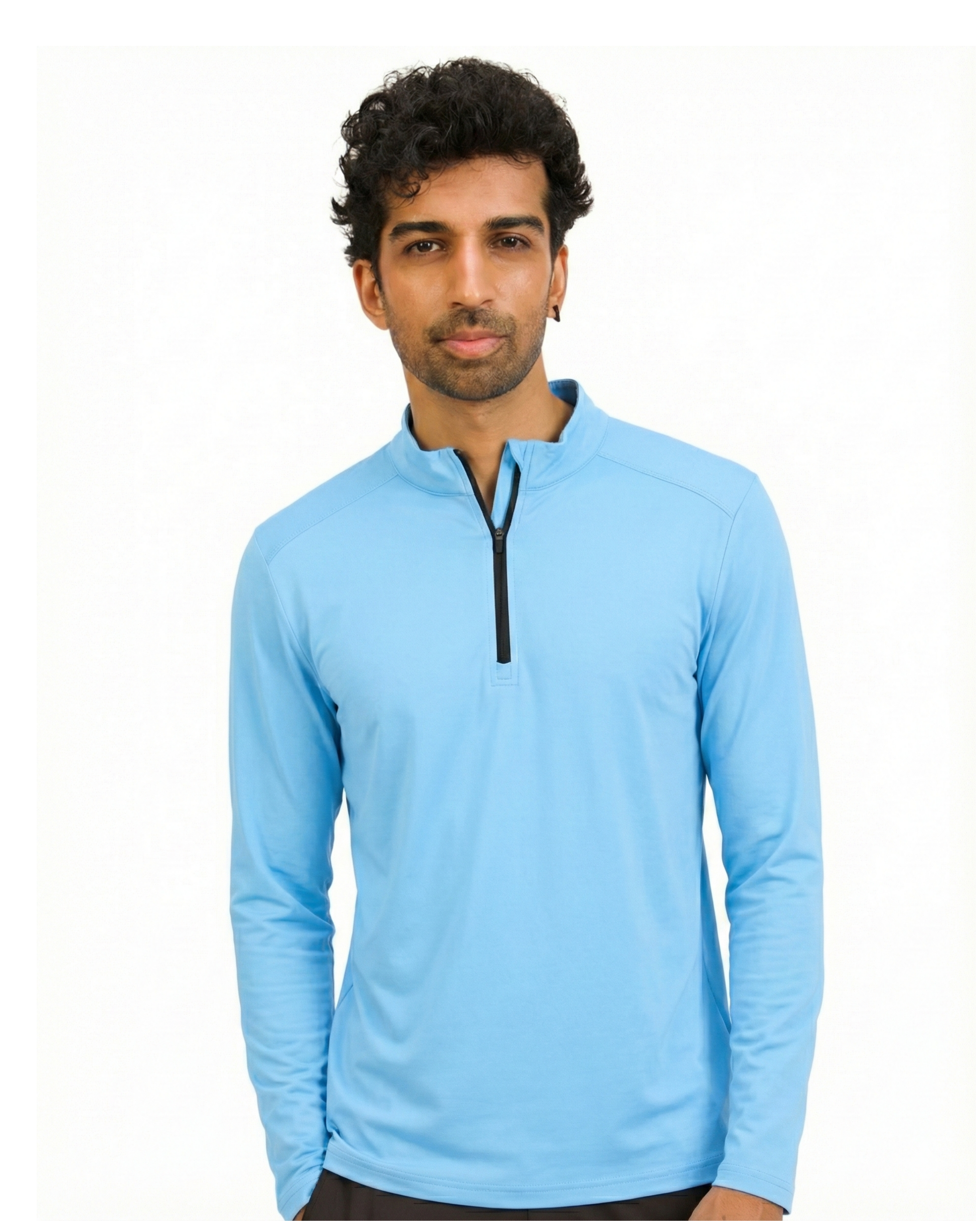 Man wearing a light blue long-sleeve shirt with a quarter zip on a white background