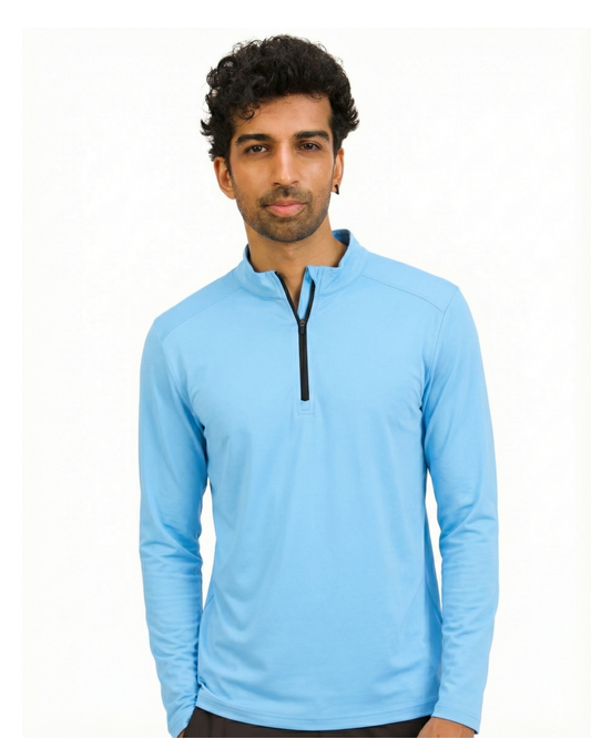 Man wearing a light blue long-sleeve shirt with a quarter zip on a white background