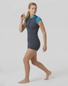 Woman wearing a gray and blue swimsuit on a white background