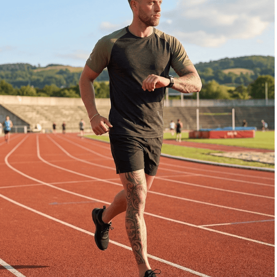 Man running on a track with a scenic background