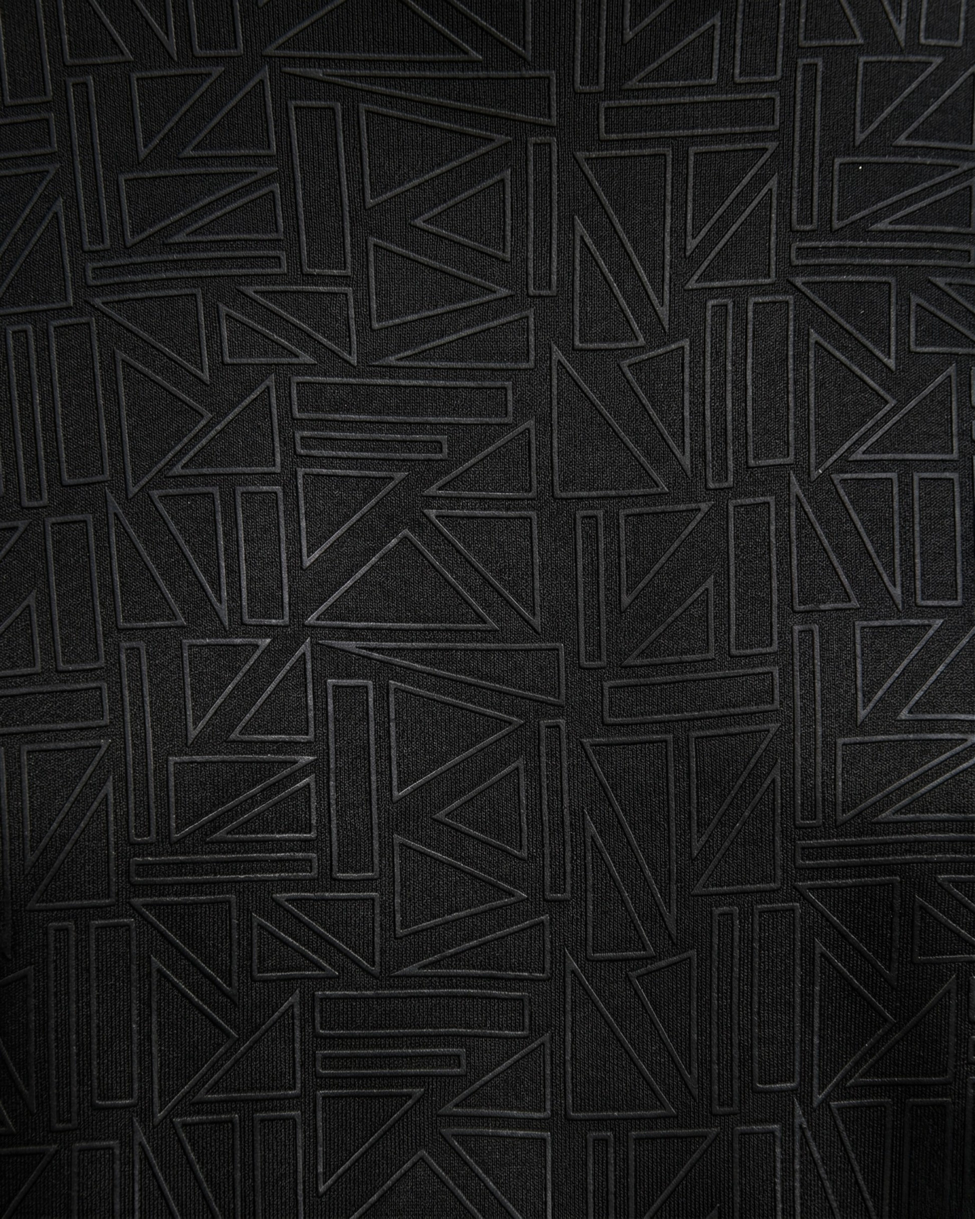 Black textured fabric with geometric pattern