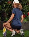 Woman in athletic wear with paddle in a garden setting