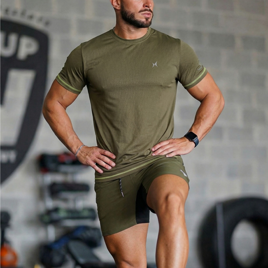 Man wearing green athletic wear in a gym setting