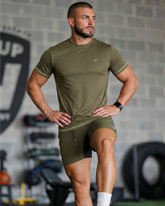 Man wearing green athletic wear in a gym setting
