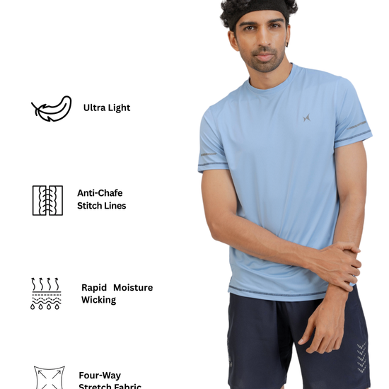 Man wearing a light blue athletic shirt and dark shorts with text on fabric features.