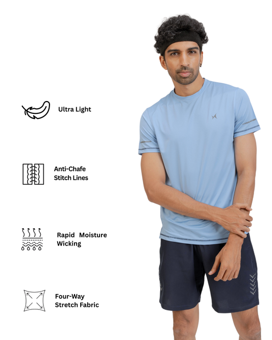 Man wearing a light blue athletic shirt and dark shorts with text on fabric features.