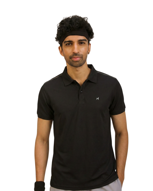 Man wearing a black polo shirt with a small logo on a white background