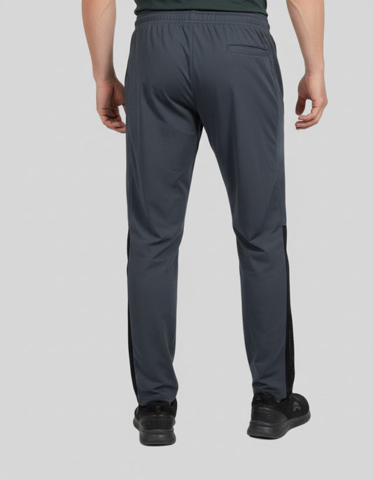 Person wearing dark gray athletic pants on a light gray background