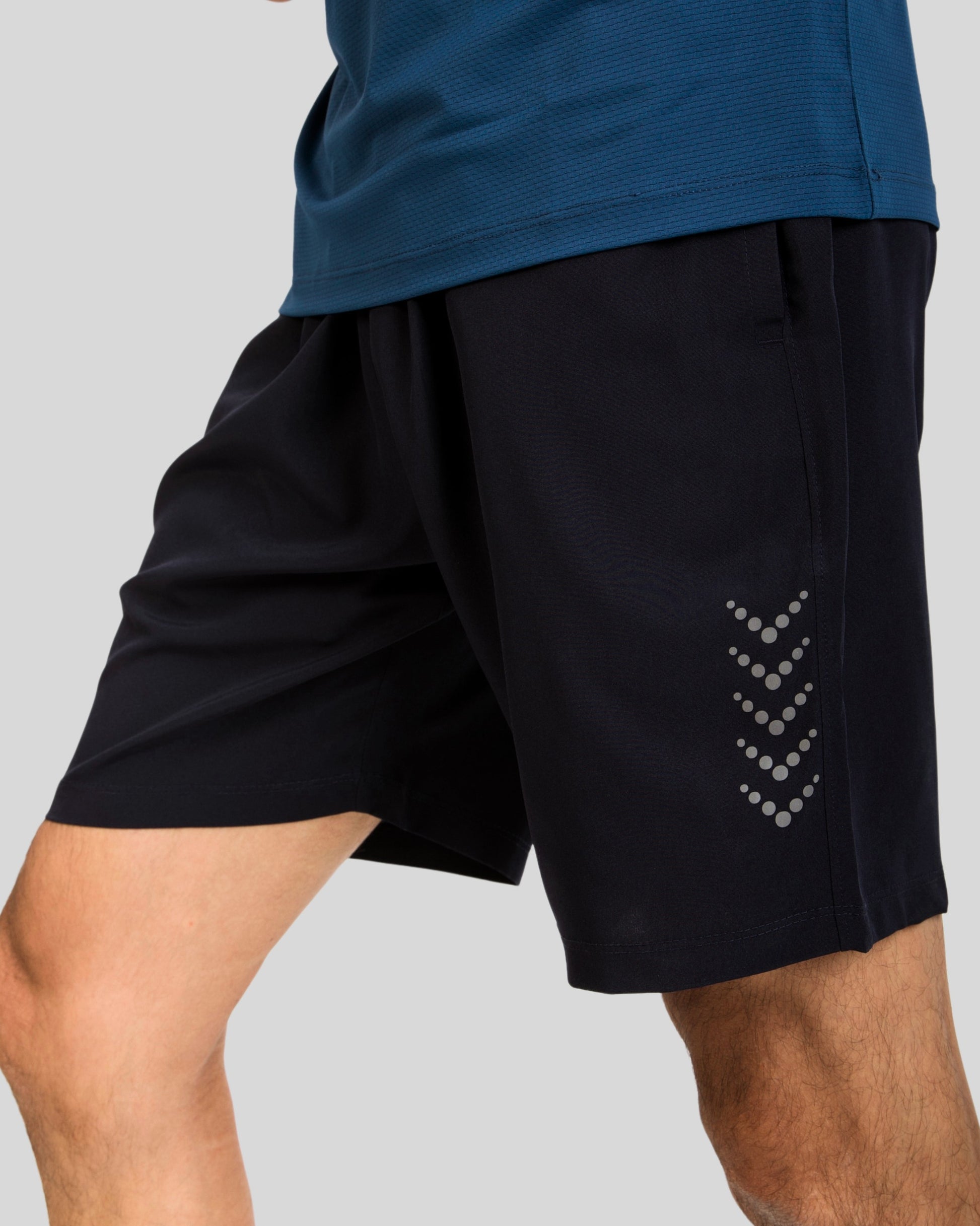 Black athletic shorts with a subtle pattern on a gray background