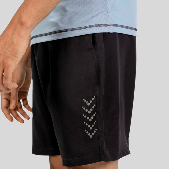 Black shorts with a subtle pattern on a gray background
