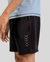Black shorts with a subtle pattern on a gray background