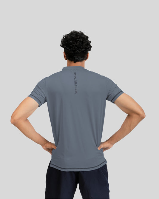 Person wearing a gray t-shirt with text on the back against a light gray background