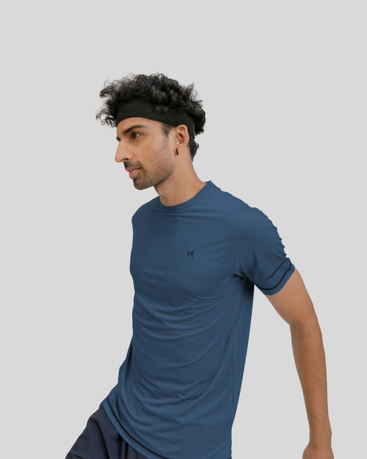 Man wearing a blue athletic outfit on a gray background