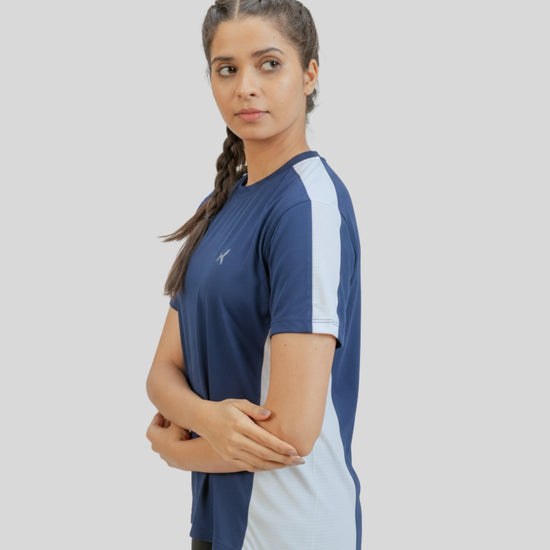 Woman wearing a blue and white athletic shirt on a gray background