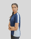 Woman wearing a blue and white athletic shirt on a gray background