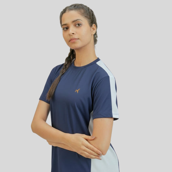 Woman wearing a blue and white athletic shirt on a plain background