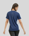 Person wearing a blue and white sports shirt with text on the back against a plain background