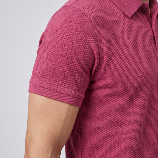 Close-up of the sleeve and bubble-knit fabric texture on a wine polo shirt
