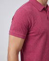 Close-up of the sleeve and bubble-knit fabric texture on a wine polo shirt